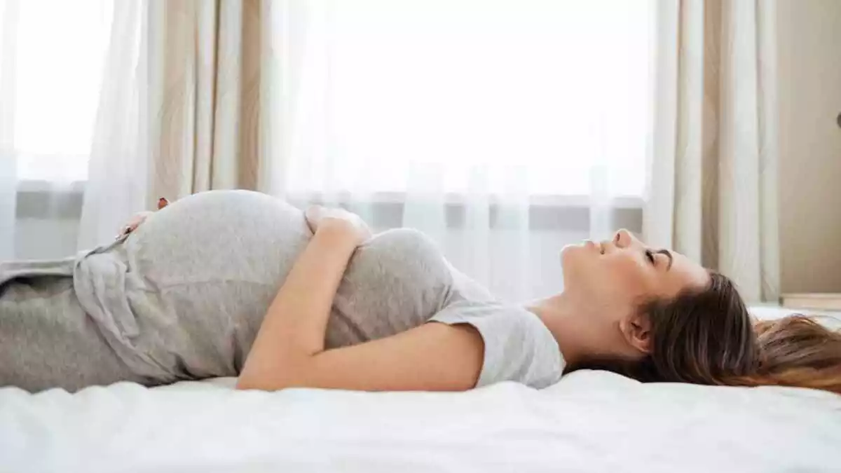 A pregnant woman lying on bed
