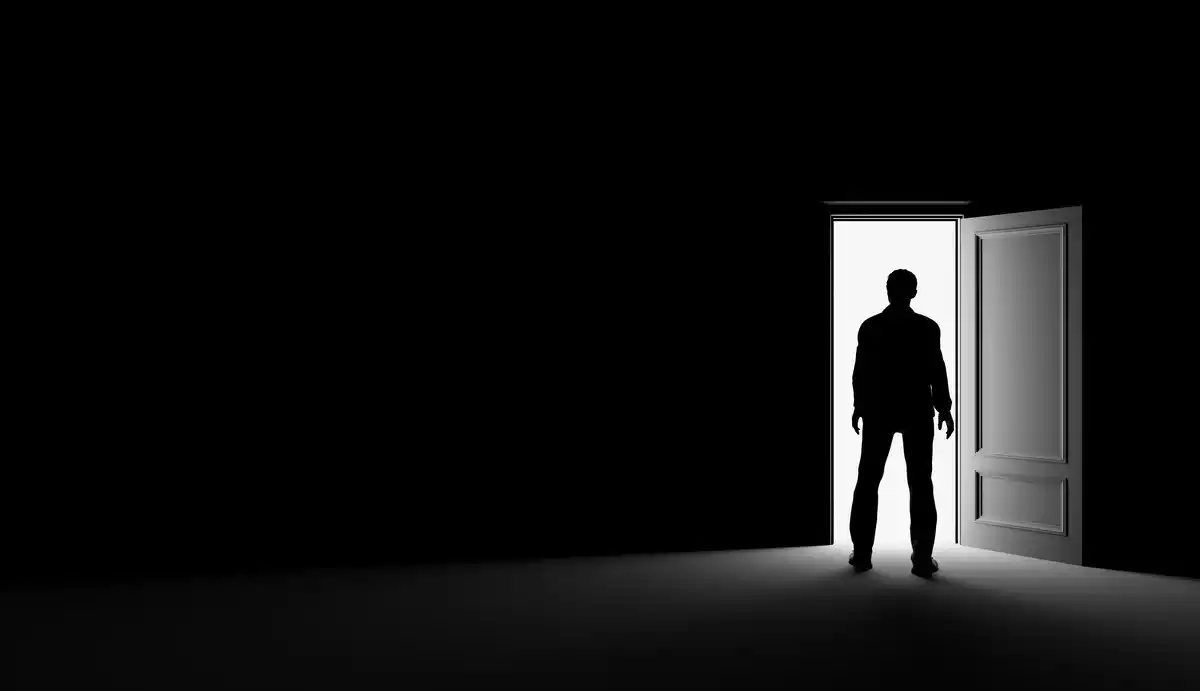 The shade of a man through the light of an open door