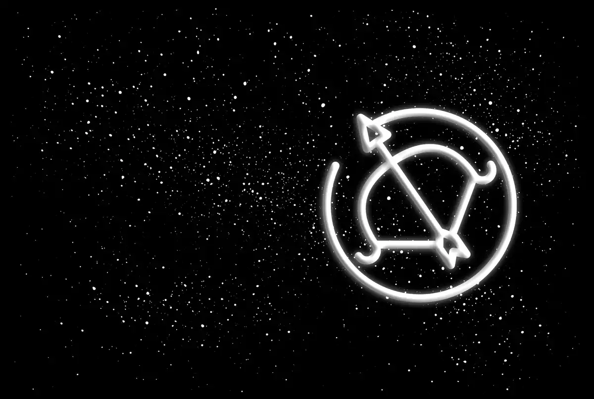 The Sagittarius sign in white on a black starred background