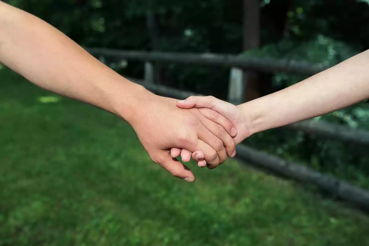 Two people holding their hand