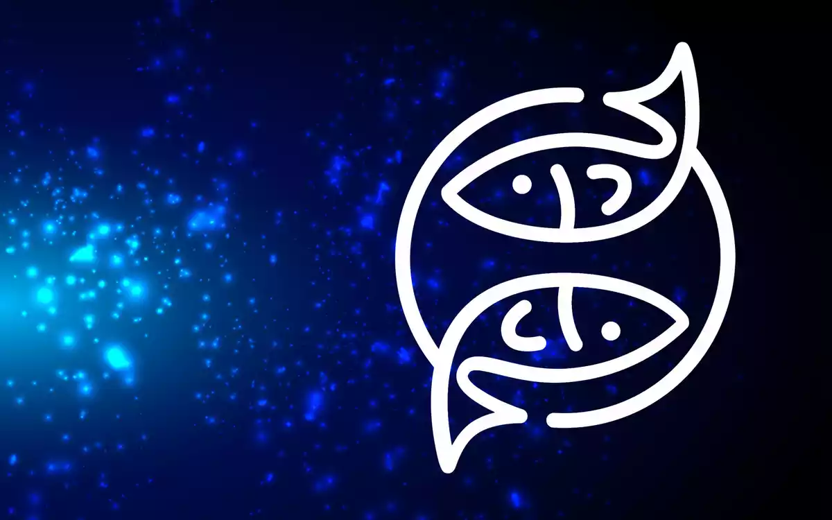 The Pisces sign in white on a blue background with some lights