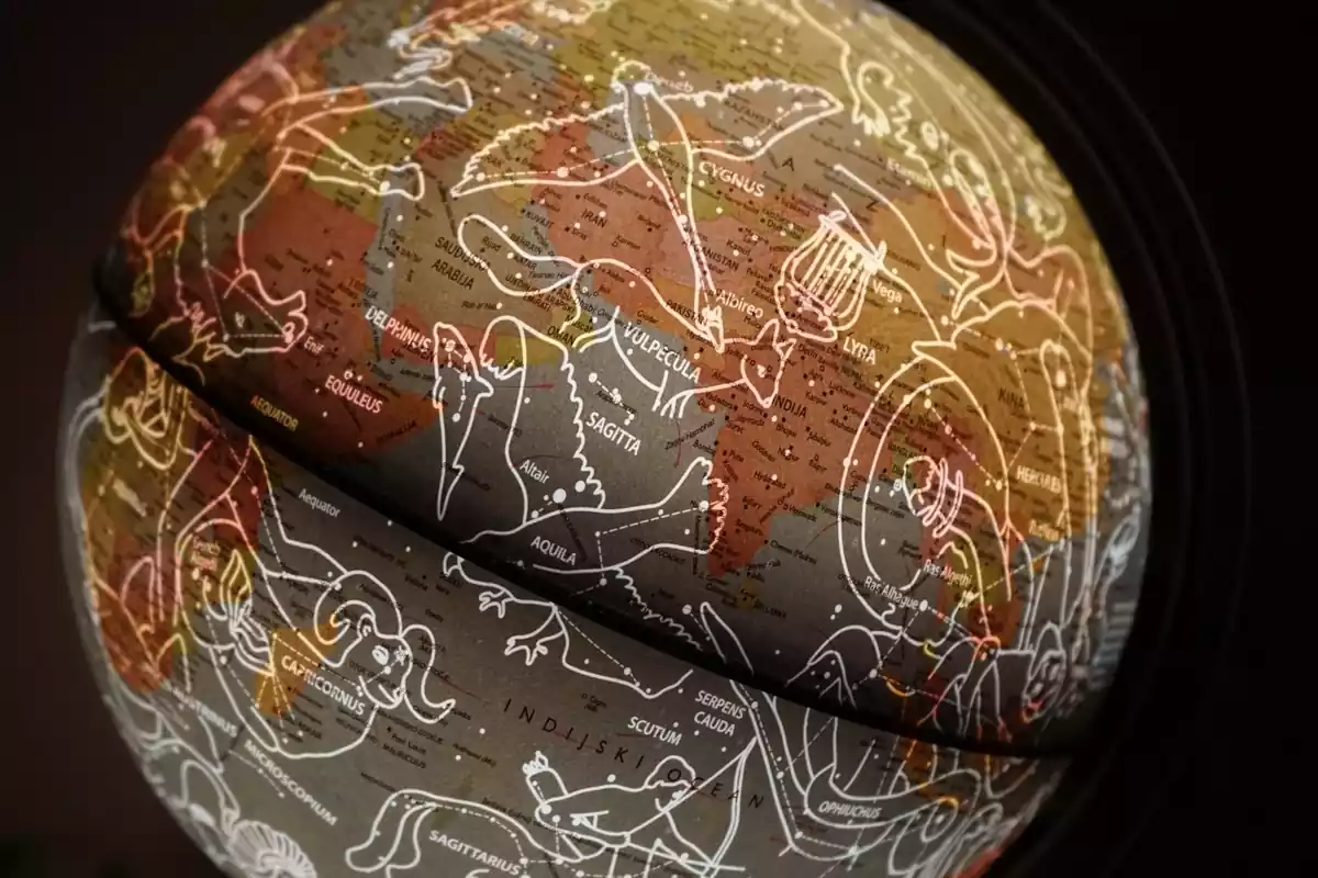 A globe in the shape of a planet with astrological symbols drawn on it