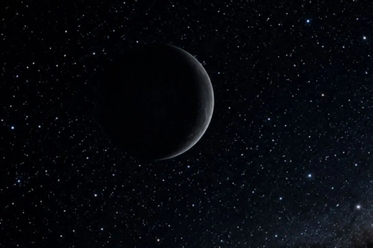 Waxing moon dimly lit against a dark, star-filled sky.